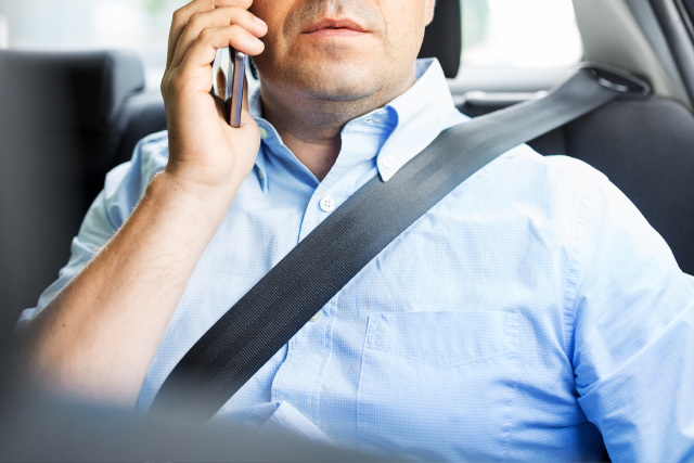 man calling on the phone as a backseat witness to the accident. 