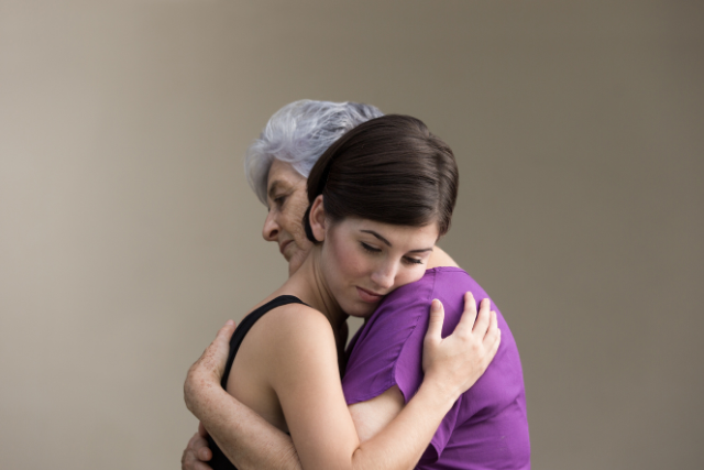 Mourning mother and adult daughter after the loss of a loved one.